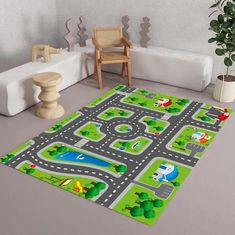 a child's play area with toy cars and roads on the floor, potted plant next to it