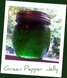 a jar filled with green liquid sitting on top of a window sill next to trees