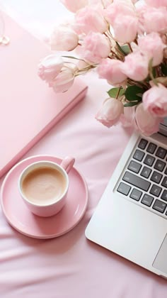 a laptop computer sitting on top of a pink table next to a cup of coffee