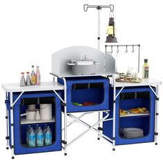 an outdoor cooking station with two blue coolers