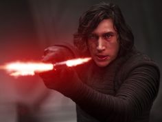 a man holding a light saber in his right hand