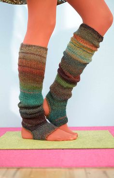 the legs and feet of a woman wearing socks with multicolored stripes on them