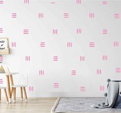 a white room with pink wallpaper and wooden flooring in front of the wall