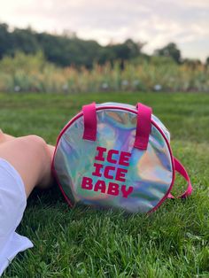 a person laying in the grass with an ice baby bag