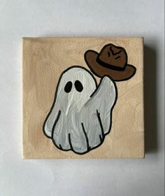 a painting of a ghost with a hat on it's head and eyes painted on wood