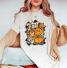 Fall Smiley Face Shirt, Cute Pumpkin Shirt, I Love Fall Shirt, Thanksgiving Shirt, Retro Fall Shirt, Vintage Autumn Leaves Tee, Fall Lovers ❀DETAIL❀ For printing, we use Bella Canvas and Gildan SoftStyle brand shirts, which are the best in the industry. *Bella Canvas -unisex size -4.2 oz. -Solid colors are 100% Combed Cotton and Ring-Spun Cotton. -Athletic Heather 90% Combed and Ring-Spun Cotton, 10% Polyester -All Heather CVC Colors 52% Combed and Ring-Spun, 48% Polyester *Gildan SoftStyle -uni Cute Pre-shrunk Shirt For Fall, Cute White Fall Shirt, Cute White Shirt For Fall, Fall White T-shirt With Screen Print, White Screen Print T-shirt For Fall, White T-shirt With Screen Print For Fall, White Graphic Print T-shirt For Fall, Fall Funny Print Short Sleeve Tops, Funny Print Short Sleeve Tops For Fall