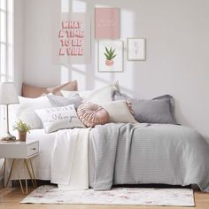 a bedroom with white walls and pink accents