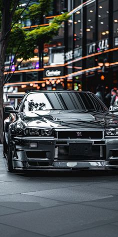 a black car is parked on the street