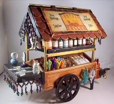 an old fashioned candy cart is decorated with beads and other things to decorate on it