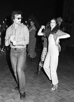 black and white photograph of two people dancing on the dancefloor at a party