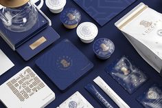 the contents of a blue and gold stationery set are laid out on a table