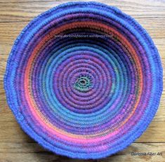 a colorful basket sitting on top of a wooden table