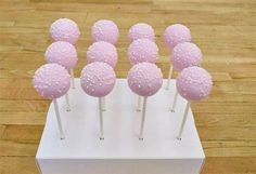 there are many pink cake pops on the stick