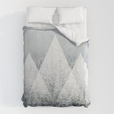 an image of a bed with white sheets and pillow cases on top of each other