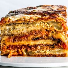 a stack of lasagna stacked on top of each other with cheese and sauce