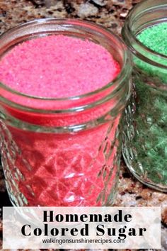 three jars filled with colored sugar sitting on top of a granite counter next to each other