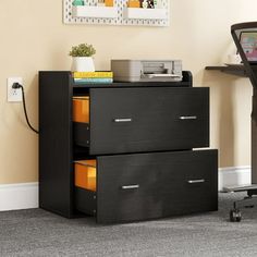 a black filing cabinet with two drawers next to a desk