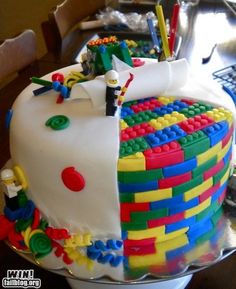 a cake made to look like legos on top of a table with a keyboard