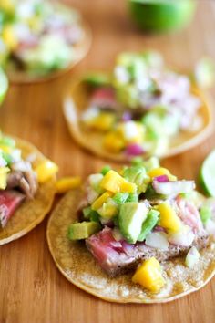 some tacos are sitting on a wooden table