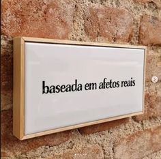 a sign that reads baseada em afteros reals on a stone wall in front of a brick building