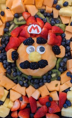 a face made out of fruits and vegetables with the word mario on it's forehead