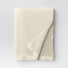 a white blanket folded on top of a table