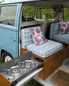 a camper van with two couches in the back