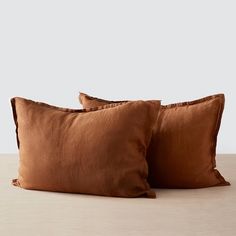 two brown pillows sitting on top of a wooden table