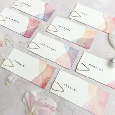 watercolor business cards with the names of different businesses on them and flowers around them