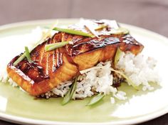 a white plate topped with meat and rice