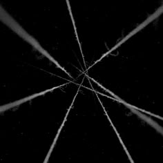 an abstract black and white photo with lines in the center that appear to be intersecting