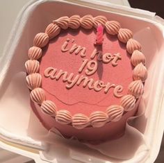 a pink birthday cake in a box with the words i'm not anymoree on it