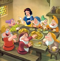 snow white and the seven dwarfs sitting at a table with food in front of them