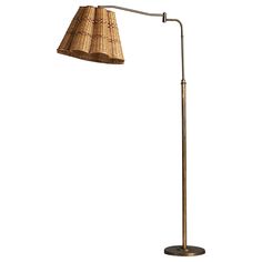 a floor lamp with a wicker shade