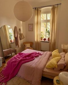 a bedroom with a bed, dresser and mirror in it's centerpieces