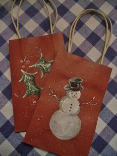 two bags with snowmen on them sitting on a table