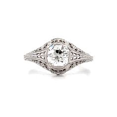 an antique style diamond ring with filigrees