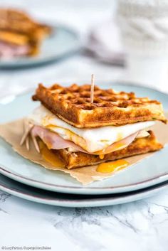 a waffle sandwich is sitting on a plate