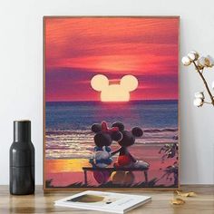 mickey and minnie mouse kissing on the beach at sunset