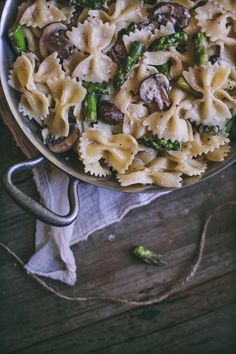 pasta with mushrooms, asparagus and parmesan cheese in a skillet