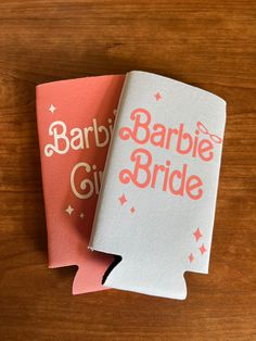 two pink and white paper bags with the words barbie bride on them sitting next to each other