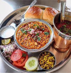 a silver tray topped with lots of different types of food on top of a table