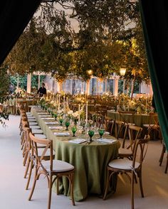 tables set up for an event with green linens