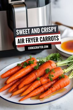 some carrots are on a plate next to an air fryer with the words, sweet and crispy air fryer carrots