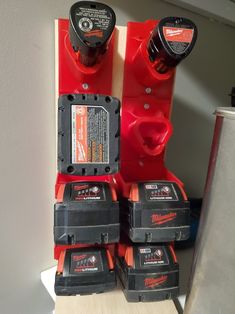 three milwaukee power tools are stacked on top of each other in front of a wall