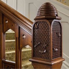 an ornate wooden grandfather clock sitting on top of a stair case