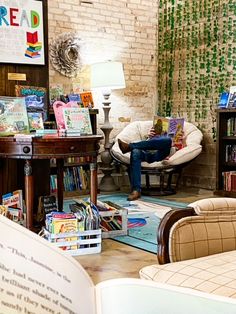 a man sitting in a chair reading a book