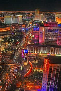 an aerial view of las vegas at night with the strip lit up in red, white and blue