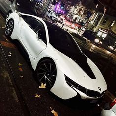 a white sports car is parked on the street