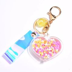 a heart shaped keychain with sprinkles on it